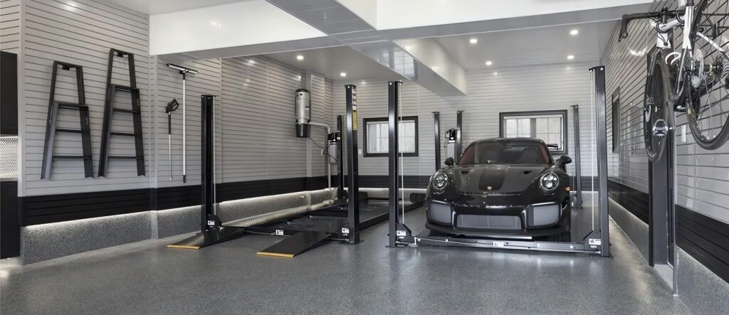 Modern garage with a luxury car and hydraulic lift.