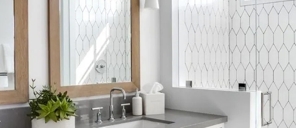 Modern bathroom sink area with sleek fixtures and tissue box.